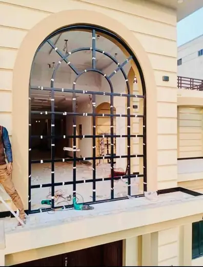 Arched aluminium window villa installation