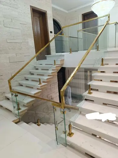 Gold fitting glass railing grand staircase