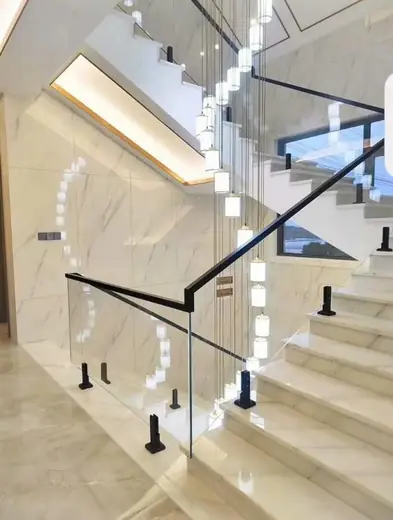 Frameless glass railing chandelier staircase