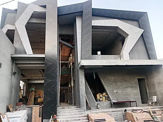Modern home facade under construction before windows and finishing