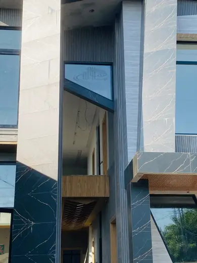 Modern home facade close-up with custom-shaped windows