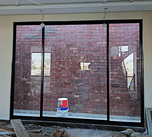 Large black frame sliding aluminium window in a new house