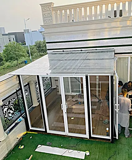 Terrace glass room with white aluminium frames and glass doors