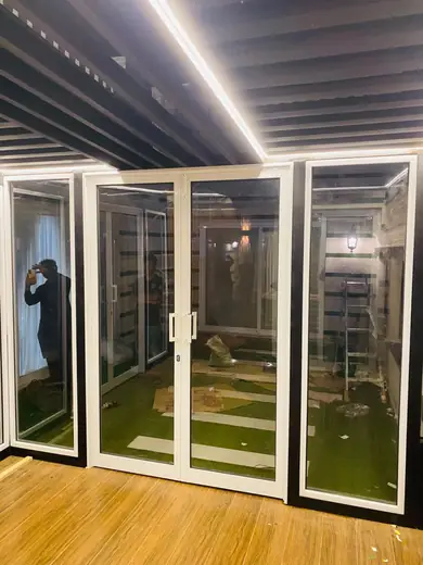 White aluminium frame glass doors in a glass room