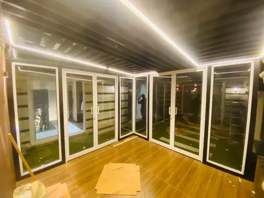 Interior glass doors with white aluminium frames and LED lighting