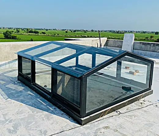 Rooftop glass skylight with black frame on a house terrace